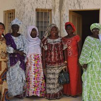 Women standing together wearing traditional clothing. 