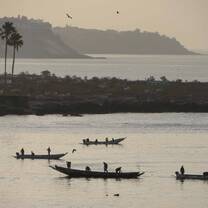 Boats calming sailing near the shore. 