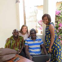 Female student smiling with her host family. 