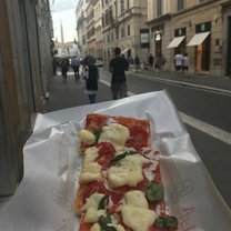 Traditional Roman pizza baked in large rectangular trays, and generally sold in rectangular or square slices by weight.