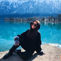 woman in black hoodie by blue lake