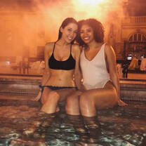 girls sitting by hottub with feet in 