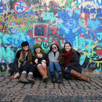 group in front of graffiti in prague