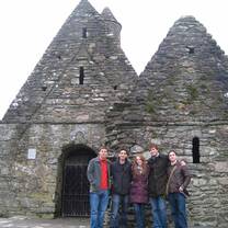 Students in front of an old stone building. 