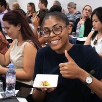 Female student of Forum-Nexus Study Abroad smiling and giving the thumbs up.