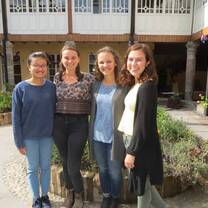 Female students standing together smiling. 