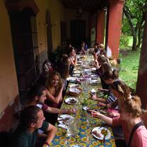 Many students sitting at a long table to share a meal. 