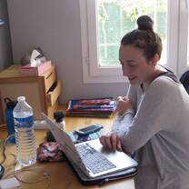 Student studying on her laptop in her homestay. 