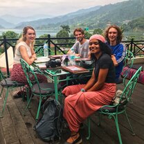 Weekend off at Pokhara This picture was taken in Pokhara, a city 200 km from Kathmandu. I was with a girl from ireland, a guy from New zealand, another guy from USA and other guy from Canada. 40 minutes after we took this picture another 10 volunteers joined us at this amazing rooftop.