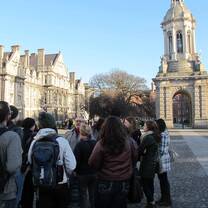 Students waiting outside for a tour of a building. 