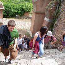 Students walking up stone stairs outside. 