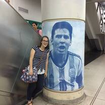 Image description: I am standing in a subway station with a massive image of Messi, the famous Argentina soccer player. 