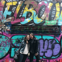 Interns pose in front of street art in Melbourne