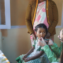 A child being given a vitamin during a routine check up!