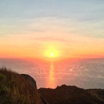 The view of the spectacular sun rising up over the vast Pacific Ocean.