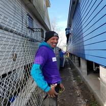 Construction Crew Leader, Darren, posing and checking out a freshly finished exterior paint job.