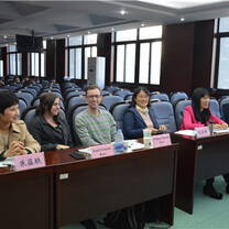 group of students sitting in the front row of a large auditorium