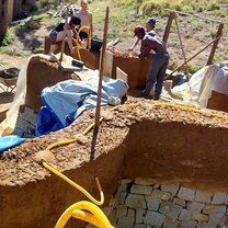 Cobbing a wall with the other volunteers