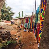 The image shows a local fabric-printing business in Ghana's Ashanti Region.