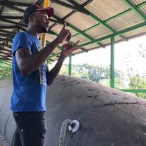 EARTH University senior Mark giving a tour explaining the biogas digester