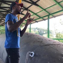 EARTH University senior Mark giving a tour explaining the biogas digester