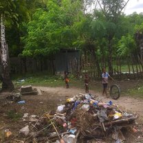 Dominican kids playing with a tire in the bateyes