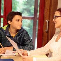 Student and teacher reviewing a piece of work 