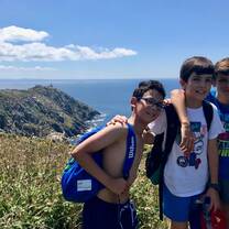 Teens in front a sunny coastline