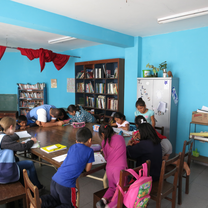Children getting help with their homework in the library