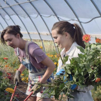 two girls in a greenhouse