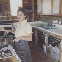 Off grid living girl cooking in house
