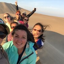 students enjoying the desert and sand boarding during their excursion south of Lima Excursion to Ica - Study Abroad EdOdyssey