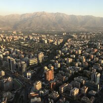 View of part of Santiago tucked in front of the nearby Andes Mountains from the top of Costanera Center, the tallest building in South America.