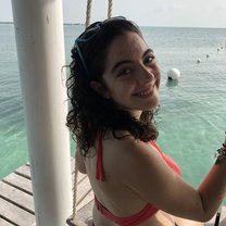 A swing overlooking very clear water in Caye Caulker