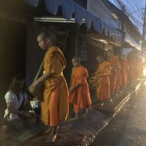 The traditional Buddhist Alms Ceremony - providing offerings to monks