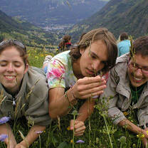 Happy students in France hiking on hills and looking at flowers