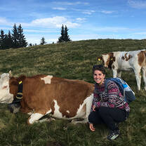 AFS Exchange student smiling with cow in Switzerland