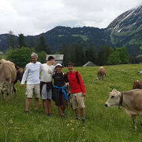 AFS Exchange students smiling with cows in Switzerland nature