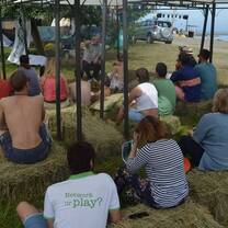 Outdoor classroom on haystacks talking about global warming and environmental protection.