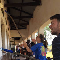 Interns participate in a school painting activity during supplementary sessional 