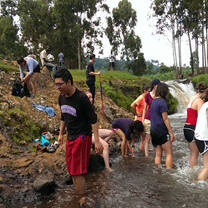 Interns taking time to relax on the river while on long hike during the midterm retreat