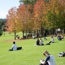 Students enjoying the sunshine by the Macqaurie lake