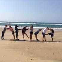Students spell AFRICA on the beach with Bold Earth Adventures.