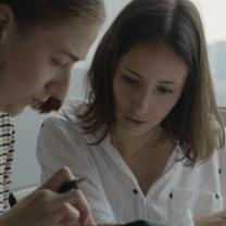 woman teaching girl