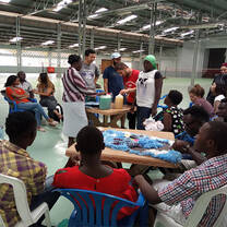 Community representative and students explain the products from the soap making project.