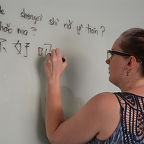 woman teaching in front of whiteboard