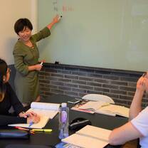 woman teaching in front of whiteboard