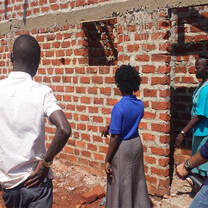 Students explain to project stakeholders about their secondary school washroom construction project.