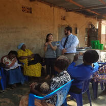 Students conducting a catering business training workshop with local women 