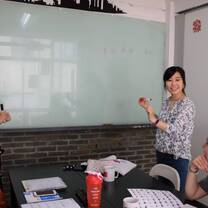 woman teaching in front of whiteboard
